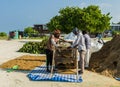 Workers sifting sand Maldives, Indian Ocean, Kaafu Atoll, Kuda Huraa Island Royalty Free Stock Photo